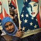 People carry posters during a rally against Trump’s original executive order banning travel from seven Muslim-majority nations, in New York’s Times Square, Sunday, Feb. 19, 2017. Photo via AP